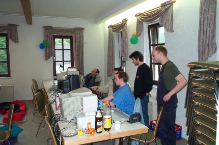 [Photo: People crowded around machines]