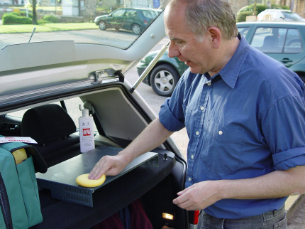 [Photo: Mark Branson applying a layer of polish]