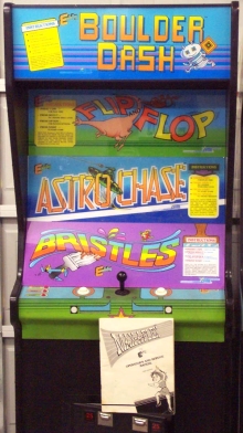 [Photo: A Max-A-Flex cabinet with marquees for all four games]