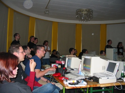 [Photo: People watching demos]