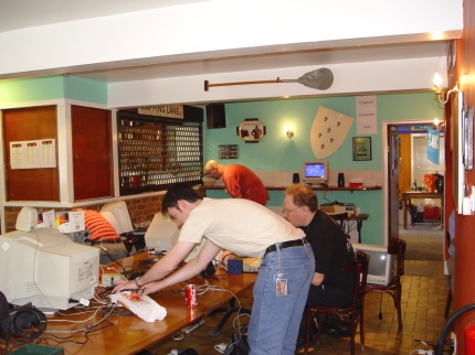 [Photo: Matthew Preston removing the last of his things from the central table]