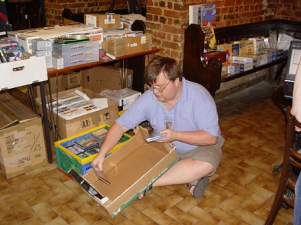 [Photo: Nick Harlow stacking up software for sale]