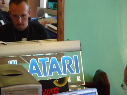 [Photo: Neon Atari sign]