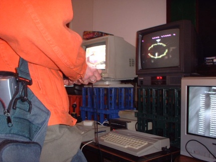 [Photo: Mike playing Gyruss on the 65XE]