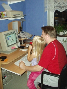 [Photo: Erik with Victoria, his daughter, browsing the MyAtari web site]