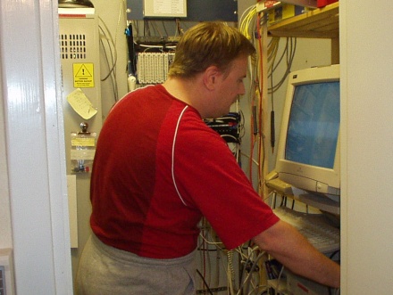 [Photo: Erik tinkering with his server]